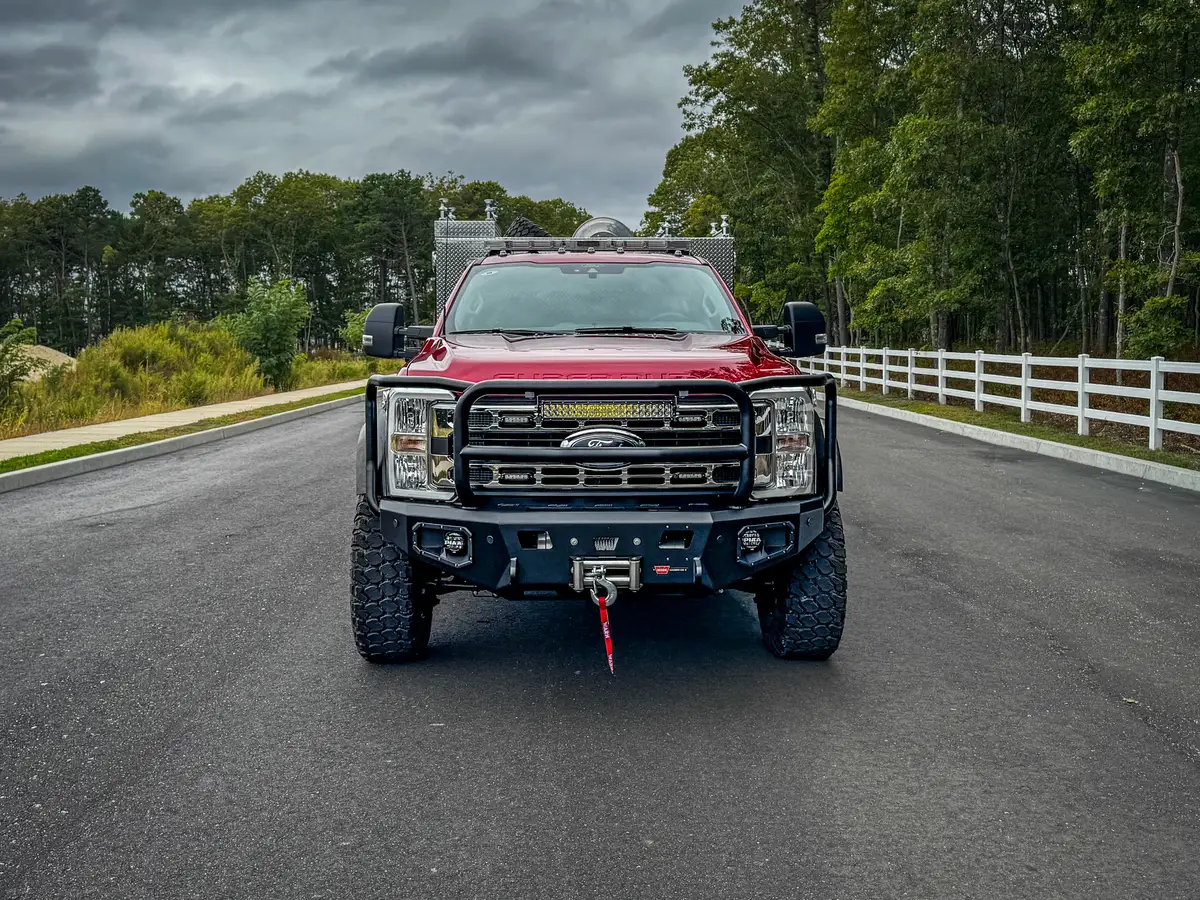Head-on front exterior view showing grille guard, bumper, and front tire stance.
